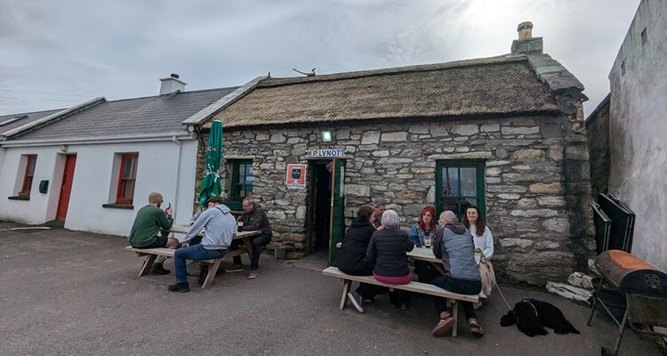 Achill-Lynotts Pub Patrons drinking outside Lynott's Pub on Achill Island