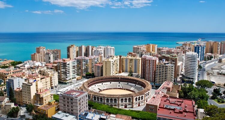 The skyline of Malaga with the Plaza de Toros bullring visible in the foreground